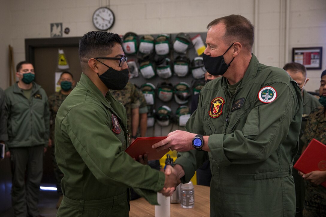 U.S. Marine Corps Lt. Gen. Mark R. Wise, the Deputy Commandant for Aviation, presents an award to a Marine with Marine Operational Test and Evaluation Squadron (VMX) 1, on Marine Corps Air Station Yuma, Ariz., Oct. 26, 2020.
