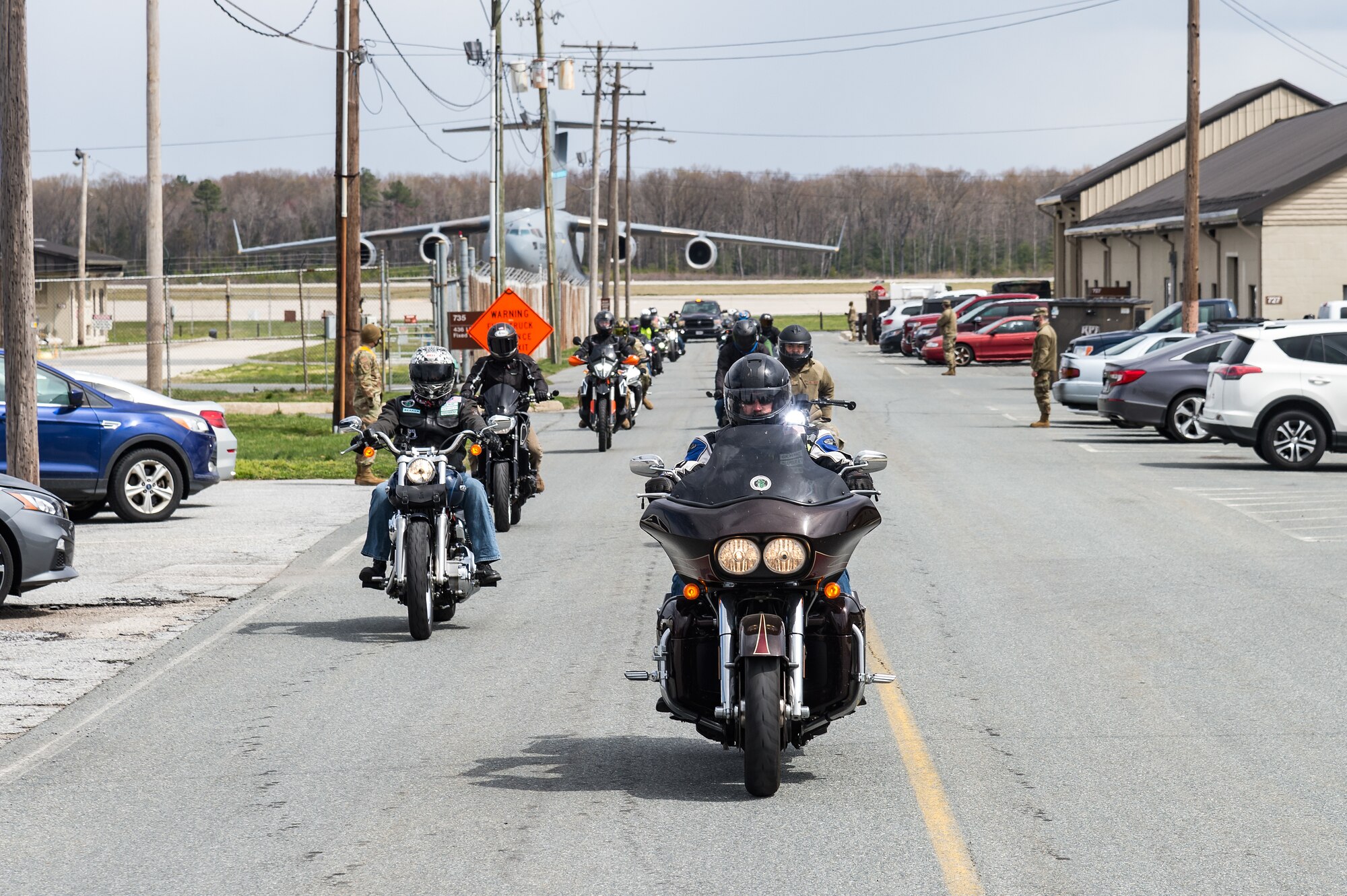 More than 20 motorcyclists ride towards the north gate on Dover Air Force Base, Delaware, April 2, 2021. The riders exited the base for a ride on the highway as part of Dover AFB’s motorcycle safety day. (U.S. Air Force photo by Roland Balik)