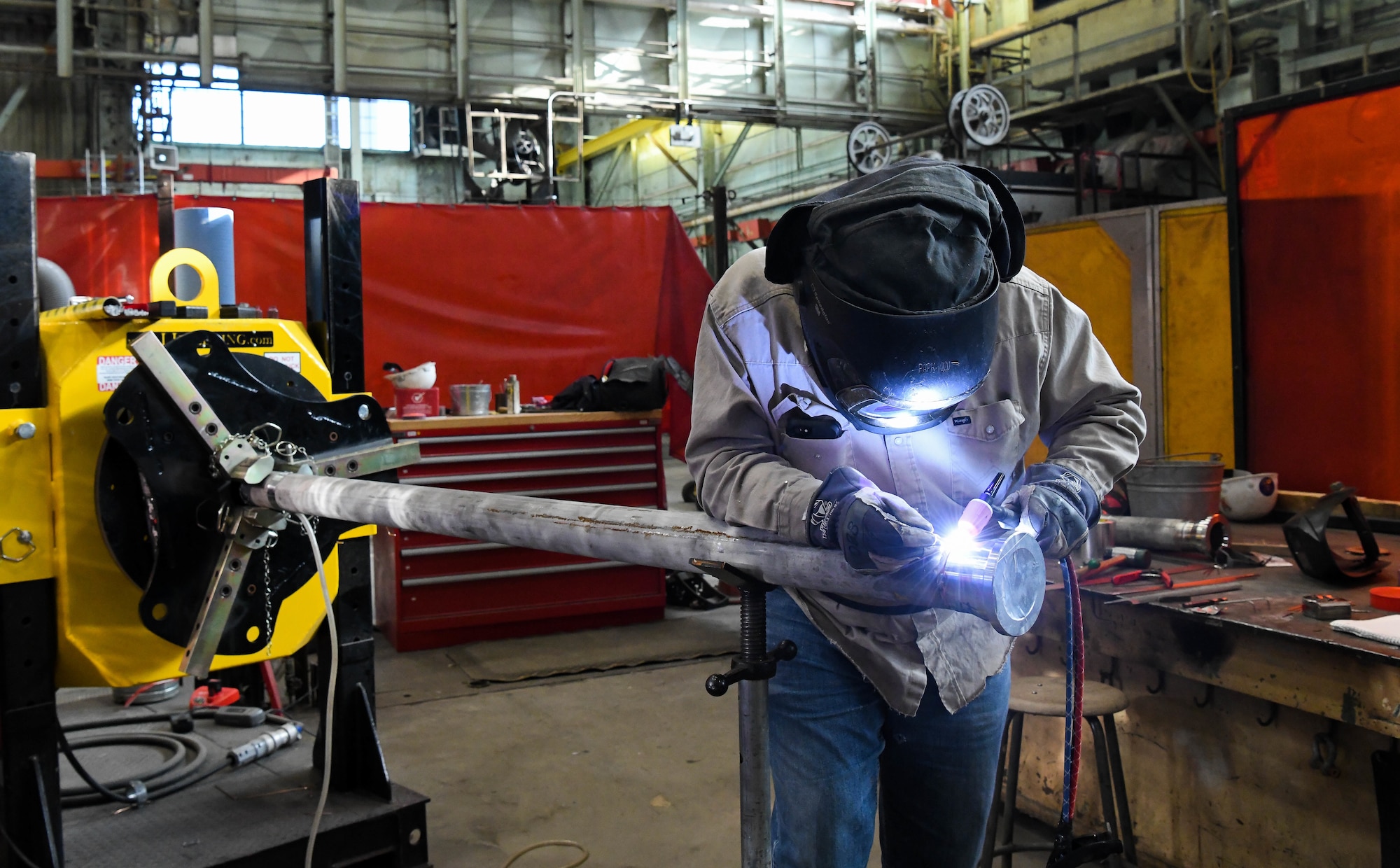 Pipefitter Billy Joe Emberton places tack welds before completely welding a flange onto a section of pipe, March 4, 2021, at the Model Shop at Arnold Air Force Base, Tenn. April is National Welding Month. (U.S. Air Force photo by Jill Pickett)