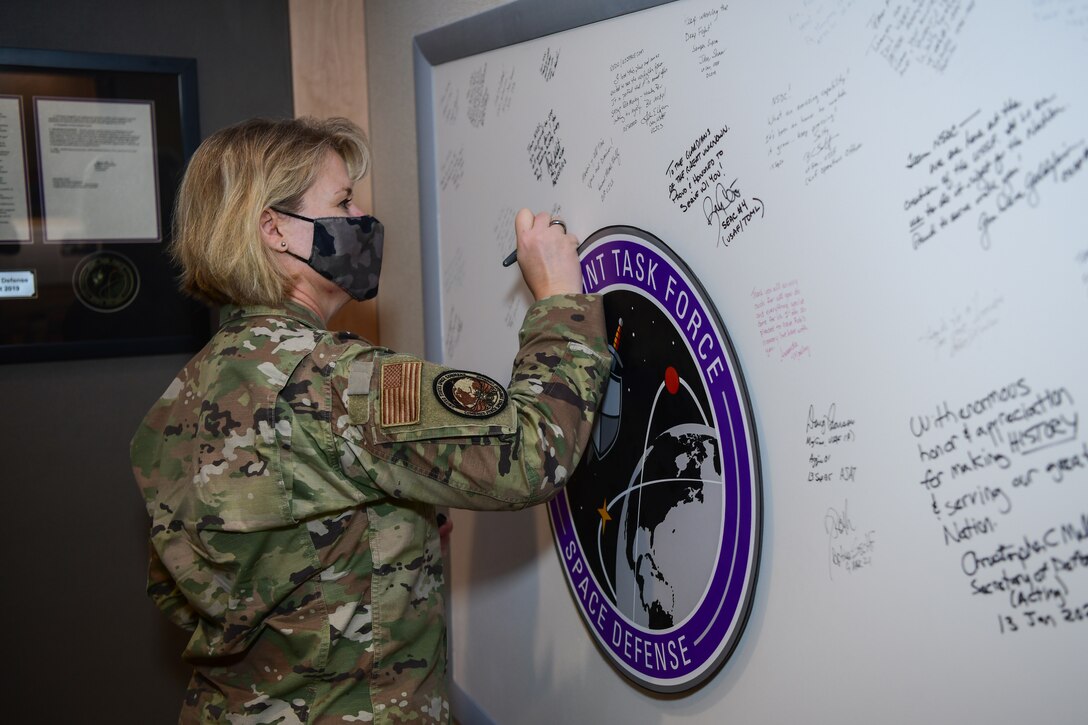 CFSCC leader signs board