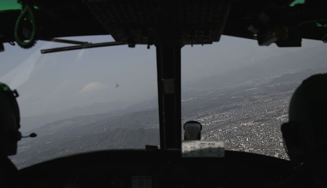 Mt. Fuji seen through the window of a flying helicopter.