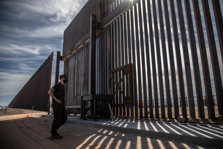 U.S. Navy Cmdr. Gareth Montgomery, the Installation & Logistics (I&L) Director, Marine Corps Air Station (MCAS) Yuma, views the ongoing construction of the border wall on the Barry M. Goldwater Range aboard MCAS Yuma, Oct 30, 2020. I&L is responsible for all military construction on the installation. (U.S. Marine Corps photo by LCpl. Gabrielle Sanders)