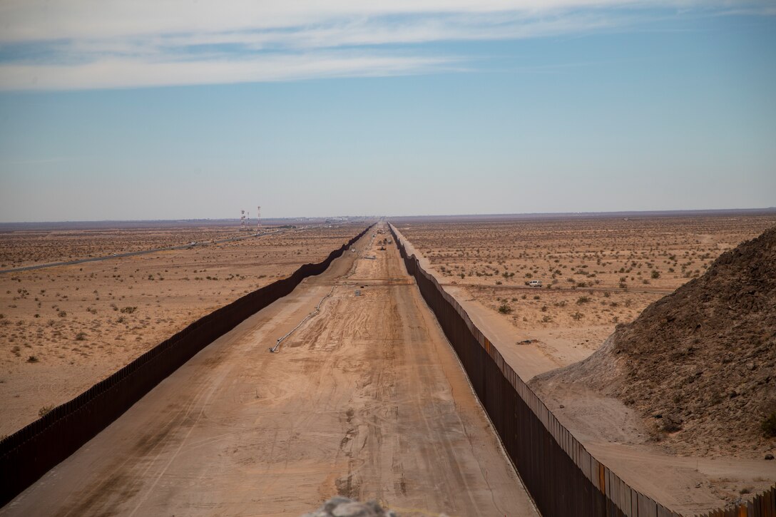 U.S. Navy Cmdr. Gareth Montgomery, the Installation & Logistics (I&L) Director, Marine Corps Air Station (MCAS) Yuma, views the ongoing construction of the border wall on the Barry M. Goldwater Range aboard MCAS Yuma, Oct 30, 2020. I&L is responsible for all military construction on the installation. (U.S. Marine Corps photo by LCpl. Gabrielle Sanders)