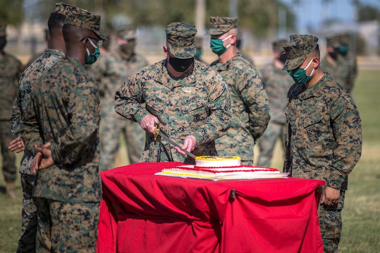 U.S. Marines with Marine Corps Air Station (MCAS) Yuma, participate in the 245th Marine Corps birthday cake cutting ceremony at the Parade Deck on MCAS Yuma, Ariz., Nov. 5, 2020. The annual ceremony was held in honor of the 245th Marine Corps birthday, signifying the passing of traditions from one generation to the next. (U.S. Marine Corps photo by Lance Cpl. John Hall)