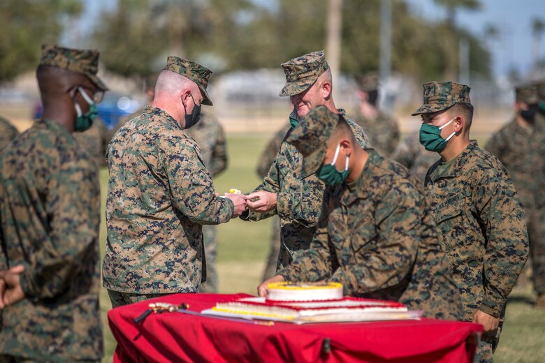 U.S. Marines with Marine Corps Air Station (MCAS) Yuma, participate in the 245th Marine Corps birthday cake cutting ceremony at the Parade Deck on MCAS Yuma, Ariz., Nov. 5, 2020. The annual ceremony was held in honor of the 245th Marine Corps birthday, signifying the passing of traditions from one generation to the next. (U.S. Marine Corps photo by Lance Cpl. John Hall)