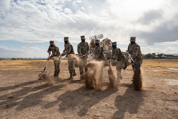 Airmen tossing sand
