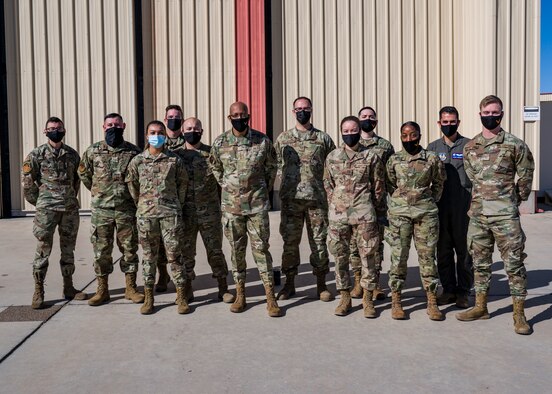 Air Force Chief of Staff Gen. Charles Q. Brown, Jr., poses for a photo with members of the 412th Test Wing during his visit to Edwards Air Force Base, Calif., March 31, 2021. During his visit, Brown met with wing leadership and was briefed on the ongoing test missions on the base.
