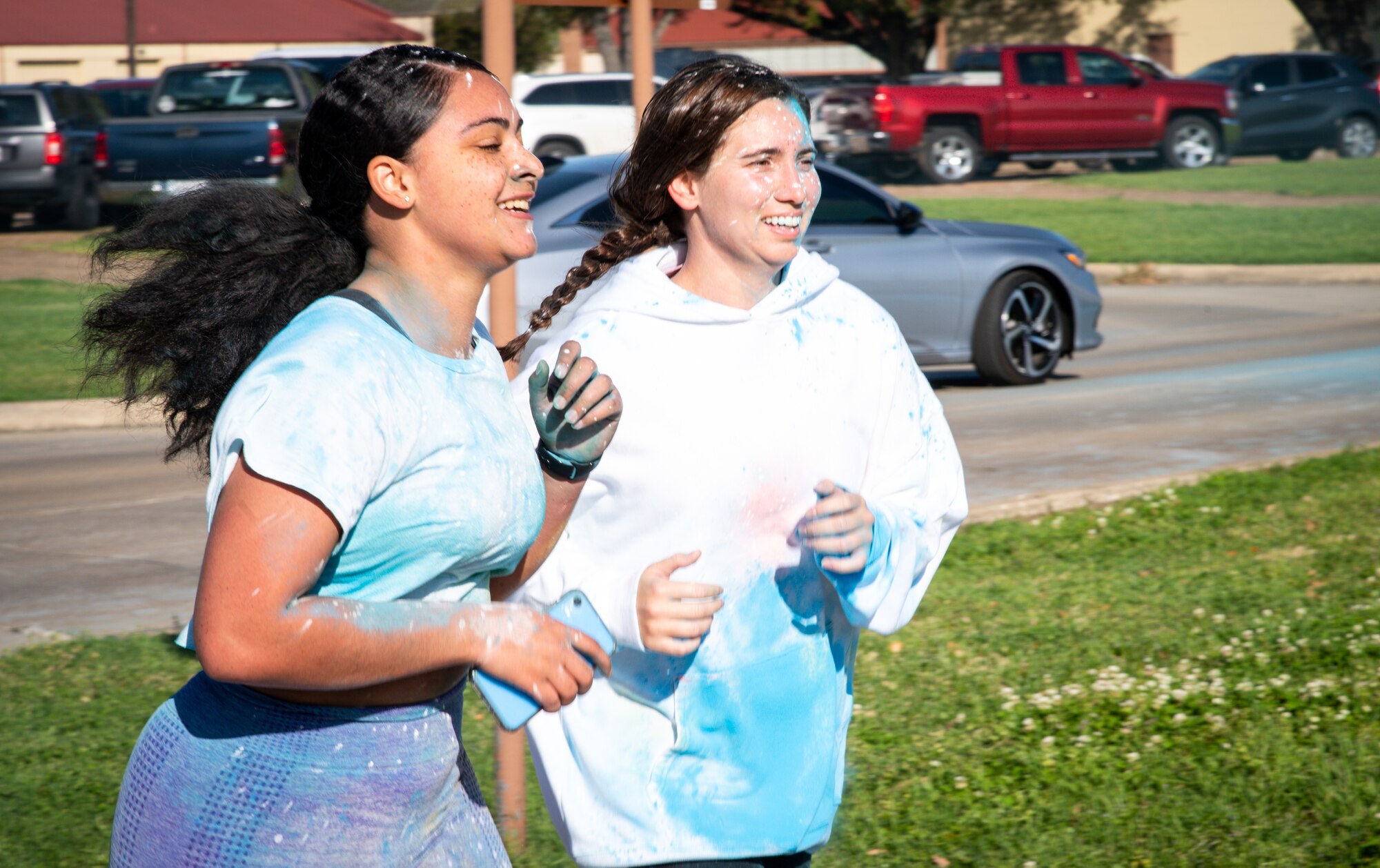 Participants in the Sexual Assault Awareness Month 5K run to the finish line at Barksdale Air Force Base, Louisiana, April 2, 2021.