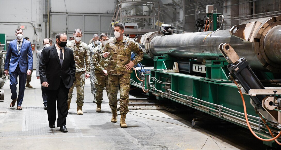 Jonathan Carroll, front left, capability manager for the Arnold Engineering Development Complex Hypervelocity Flyout, Impact and Lethality Ground Test and Evaluation, briefs Gen. David Thompson, front right, vice chief of Space Operations, U.S. Space Force, about the capability as they tour Range G at Arnold Air Force Base, Tenn., headquarters of AEDC, Feb. 5, 2021. (U.S. Air Force photo by Jill Pickett) (This image was altered by obscuring badges for security purposes.)