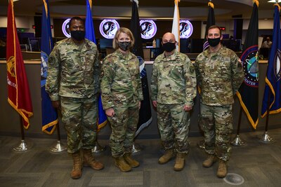 Leaders take photo on ops floor