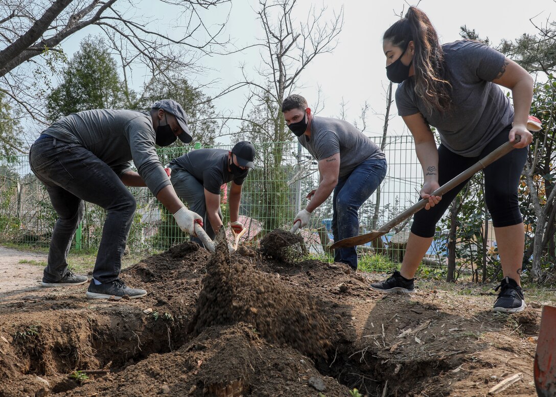 U.S. Marines with U.S. Marine Corps Forces – Korea fill in the holes created from removed tree stumps during a volunteer event at Sunrin Orphanage, Pohang, South Korea, March 13, 2021. The trees had fallen down last fall due to a strong typhoon and the rocks had become safety hazards for the children. The event encapsulates the strong bond between the Marine Corps and the orphanage that began with its founding in 1952.