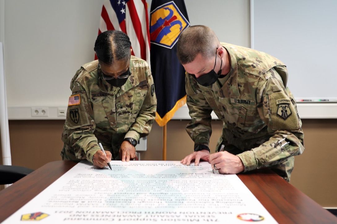U.S. Army Reserve Brig. Gen. Wanda Williams, commander of the 7th Mission Support Command, and Command Sgt. Maj. Paul Yingst, 7th MSC command sergeant major, sign the 7th MSC Sexual Assault Awareness and Prevention Month Proclamation for 2021 in Kaiserslautern, Germany, March 31, 2021. Throughout the Army, April is Sexual Assault Awareness and Prevention Month, or SAAPM.