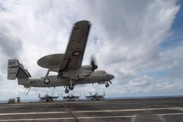 An E-2C Hawkeye, assigned to the “Liberty Bells” of Airborne Command and Control Squadron (VAW) 115, lands on the flight deck of the aircraft carrier USS Theodore Roosevelt (CVN 71) April 5, 2021.