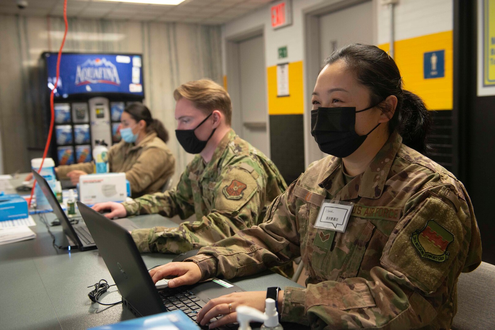 Senior Airman Can Liu, (right) from Queens, N.Y., and a 335th Expeditionary Medical Operations Squadron general purpose Airman, and two other Airmen assist community members checking-in at the state-led, federally-supported Medgar Evers College Community Vaccination Center in Brooklyn, N.Y., March 24, 2021. U.S. Northern Command, through U.S. Army North, remains committed to providing continued, flexible DoD support to the Federal Emergency Management Agency as part of the whole-of-government response to COVID-19. (U.S. Air Force photo by Tech. Sgt. Ashley Nicole Taylor)