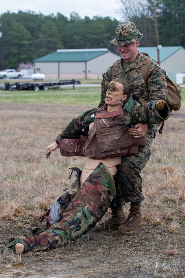 U.S. Marine Corps Capt. Matthew McGowan, an infantry officer with Headquarters Company, 6th Marine Regiment, 2d Marine Division, buddy drags a mannequin during a Division Leaders Assessment Program (DLAP) at Fort Pickett, V.A., March 28, 2021.