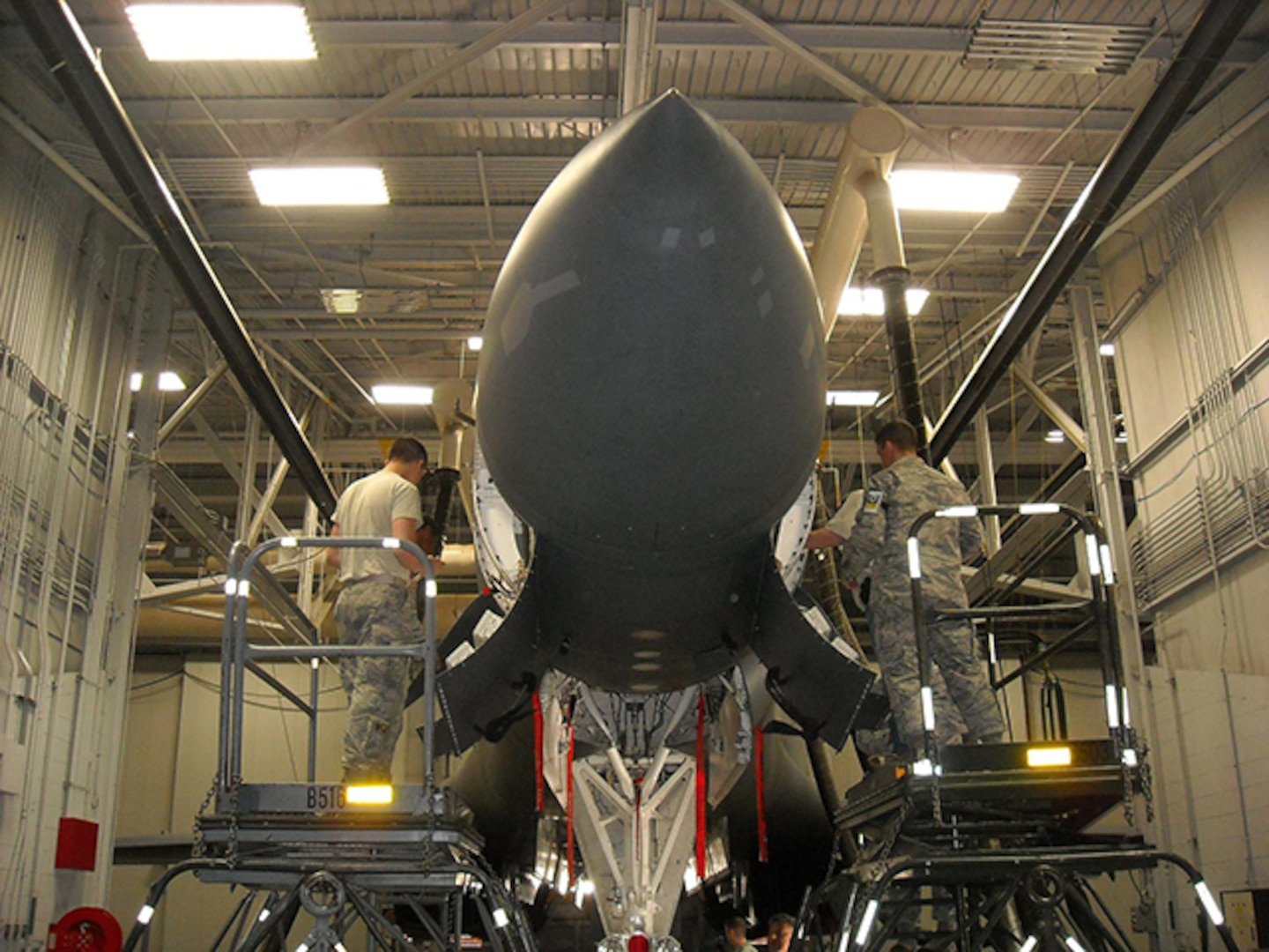 Airmen perform maintenance on B-1 bomber radar system