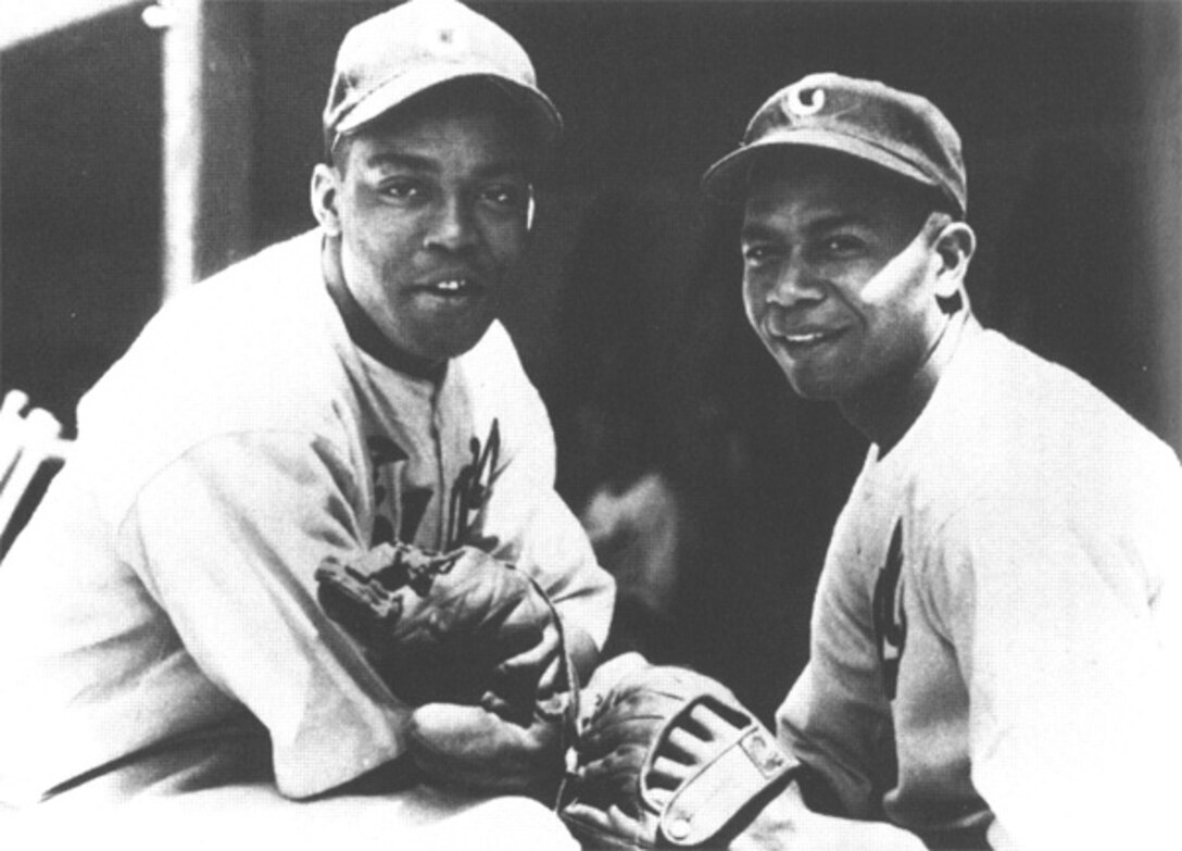 Two baseball players pose for a photo.