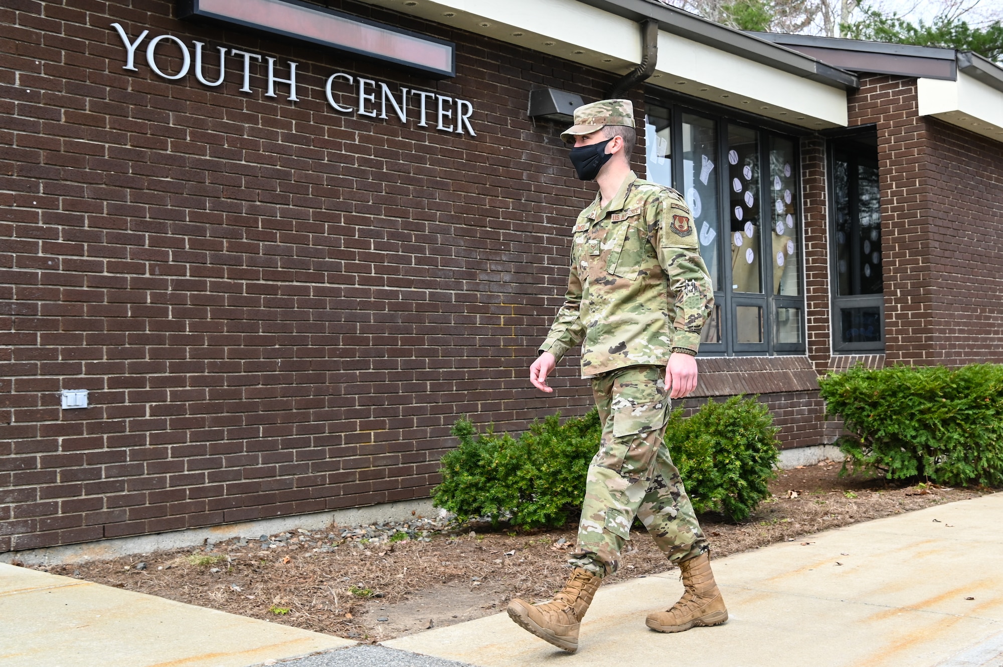Senior Airman Gage Siwicki, 66th Force Support Squadron ceremonial honor guardsman, walks into the COVID-19 vaccination site at Hanscom Air Force Base, Mass., April 6. Hanscom personnel identified in the Department of Defense prioritization schema can now use the Defense Health Agency Appointing Portal to schedule first and second dose vaccine appointments. (U.S. Air Force photo by Todd Maki)