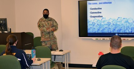 Staff Sgt. William Cox (center), an Army instructor in the Medical and Education Training Campus Occupational Therapy Assistant program, teaches Army and Navy students about heat modalities used in occupational therapy treatments.