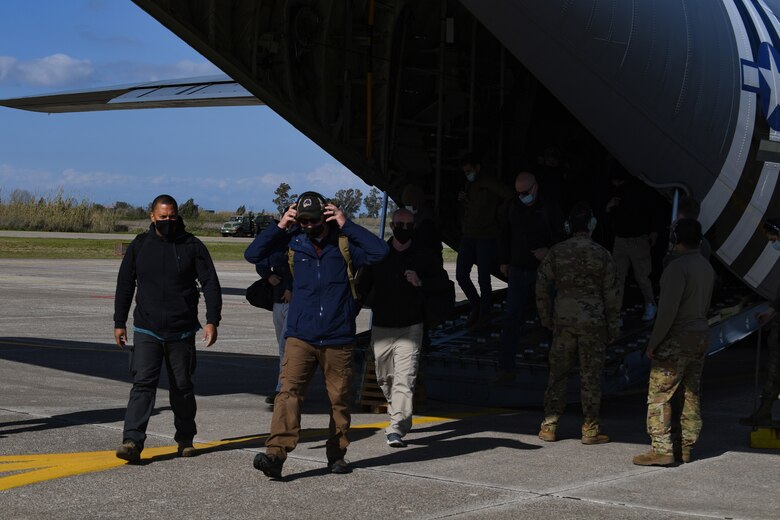 Members of the 31st Fighter Wing exit a U.S. Air Force C-130 Hercules at Andravida Air Base, Greece, April 6, 2021. The 31st FW arrived in Greece to participate in INIOCHOS 21. The U.S. Air Force has participated in INIOCHOS since 2017 and will provide Airmen, aircraft and equipment from the 31st FW this year. (U.S. Air Force photo by Airman 1st Class Thomas S. Keisler IV)