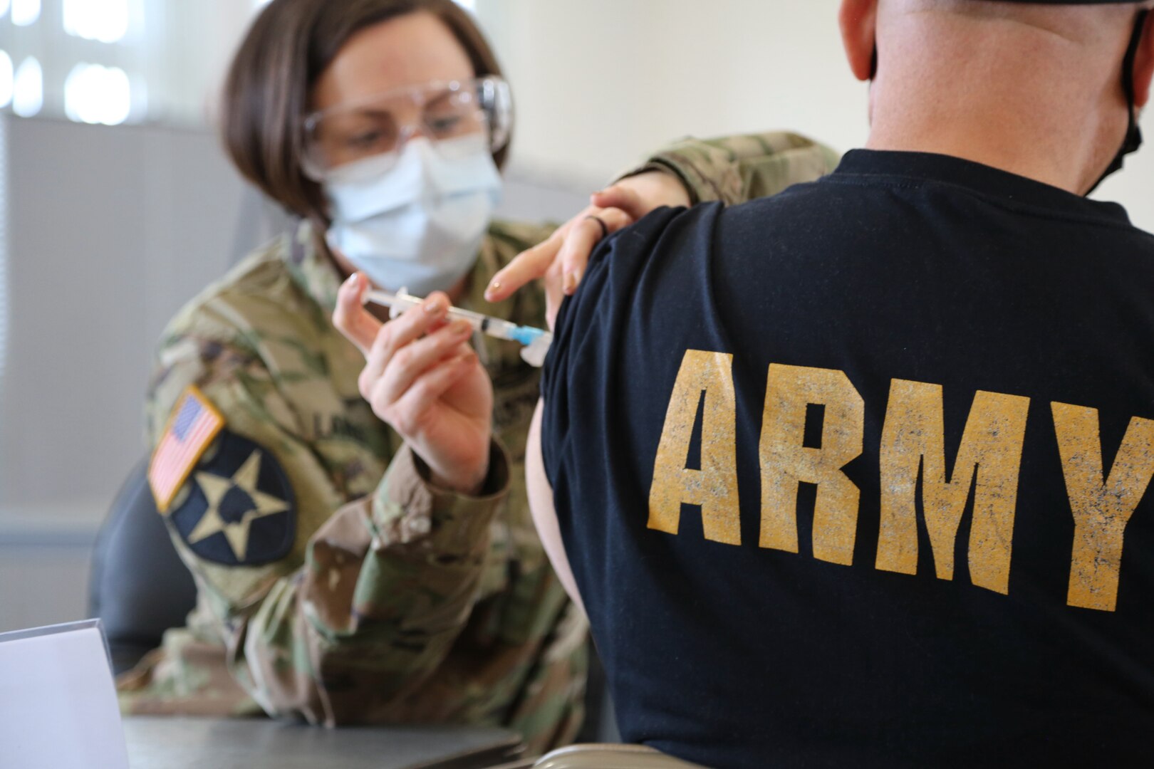 A U.S. Army Nurse administers a COVID-19 vaccine to a patient.