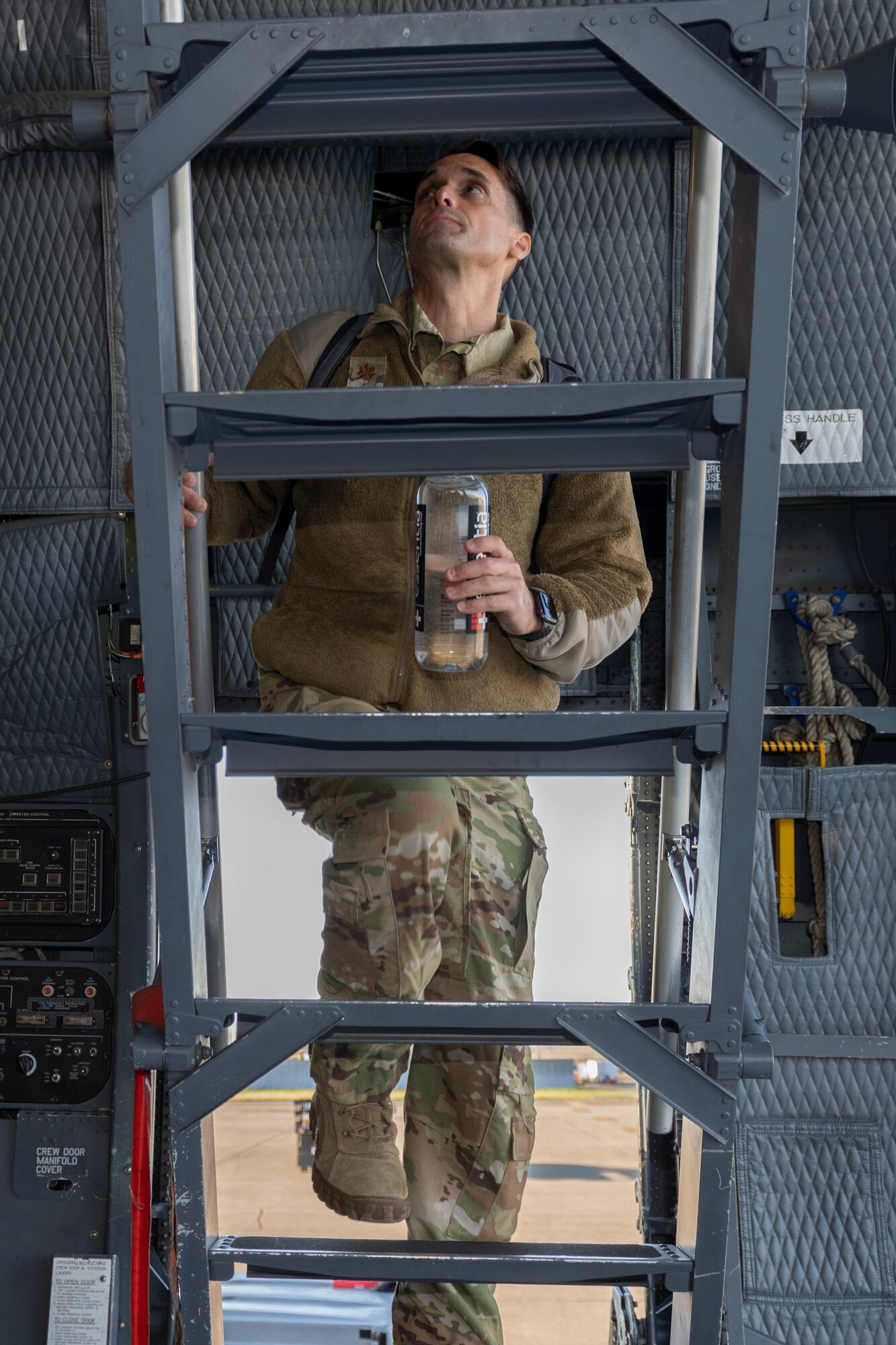 U.S. Air Force Maj. Chris Rinaman, 22nd Airlift Squadron assistant director of operations, climbs up to the flight deck of a C5-M Super Galaxy March 16, 2021, at Travis Air Force Base, California. Airmen assigned to the 22nd AS flew the C-5M to transport a satellite from Moffett AirField, California to Cape Canaveral, Florida. (U.S. Air Force photo by Senior Airman Cameron Otte)