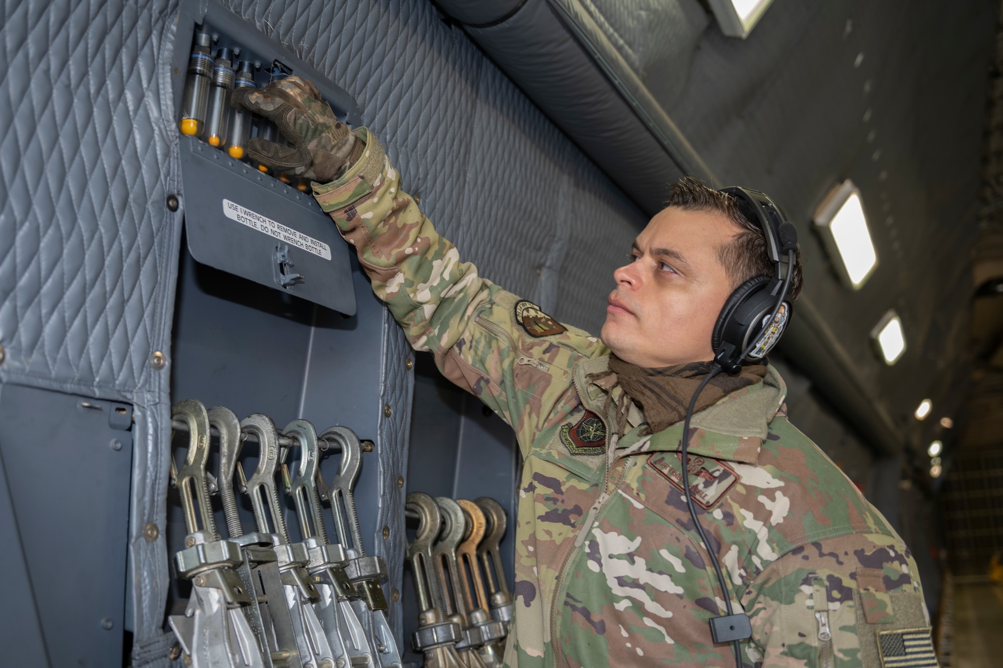 U.S. Air Force Master Sgt. Ernesto Hubble, 22nd Airlift Squadron flight engineer, performs a preflight check March 16, 2021, at Travis Air Force Base, California. Airmen assigned to the 22nd AS flew the C5-M Super Galaxy to transport a satellite from Moffett Air Field, California to Cape Canaveral, Florida. (U.S. Air Force photo by Senior Airman Cameron Otte)