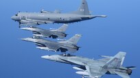 A Royal Canadian Air Force CP-140 long range patrol aircraft flies in formation with two U.S. Air Force F-16s and a RCAF CF-18.
