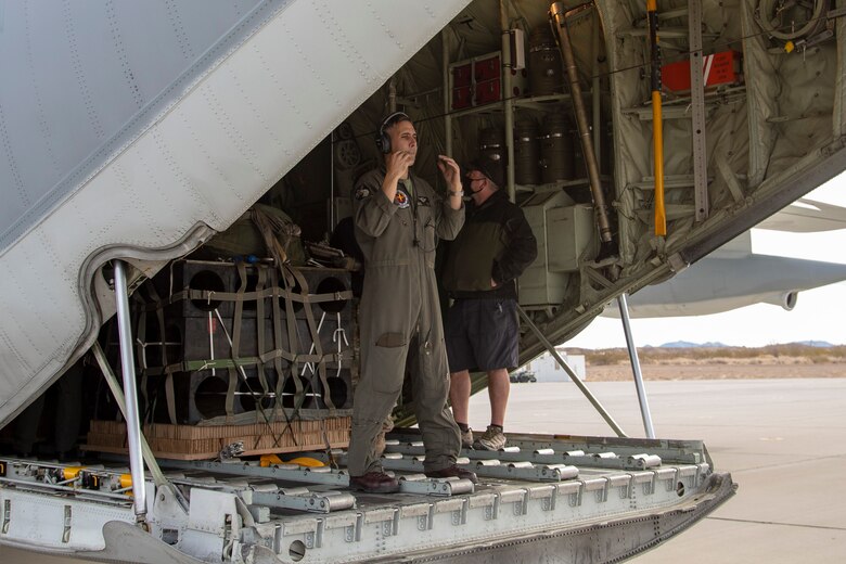 A KC-130J with Marine Aerial Refueler Transport Squadron (VMGR) 152 performs a low altitude aerial drop over Yuma Proving Grounds on January 28, 2021. This training allows for getting mission-critical supplies to troops on the ground at any given place. (U.S. Marine Corps photo by LCpl. Gabrielle Sanders)