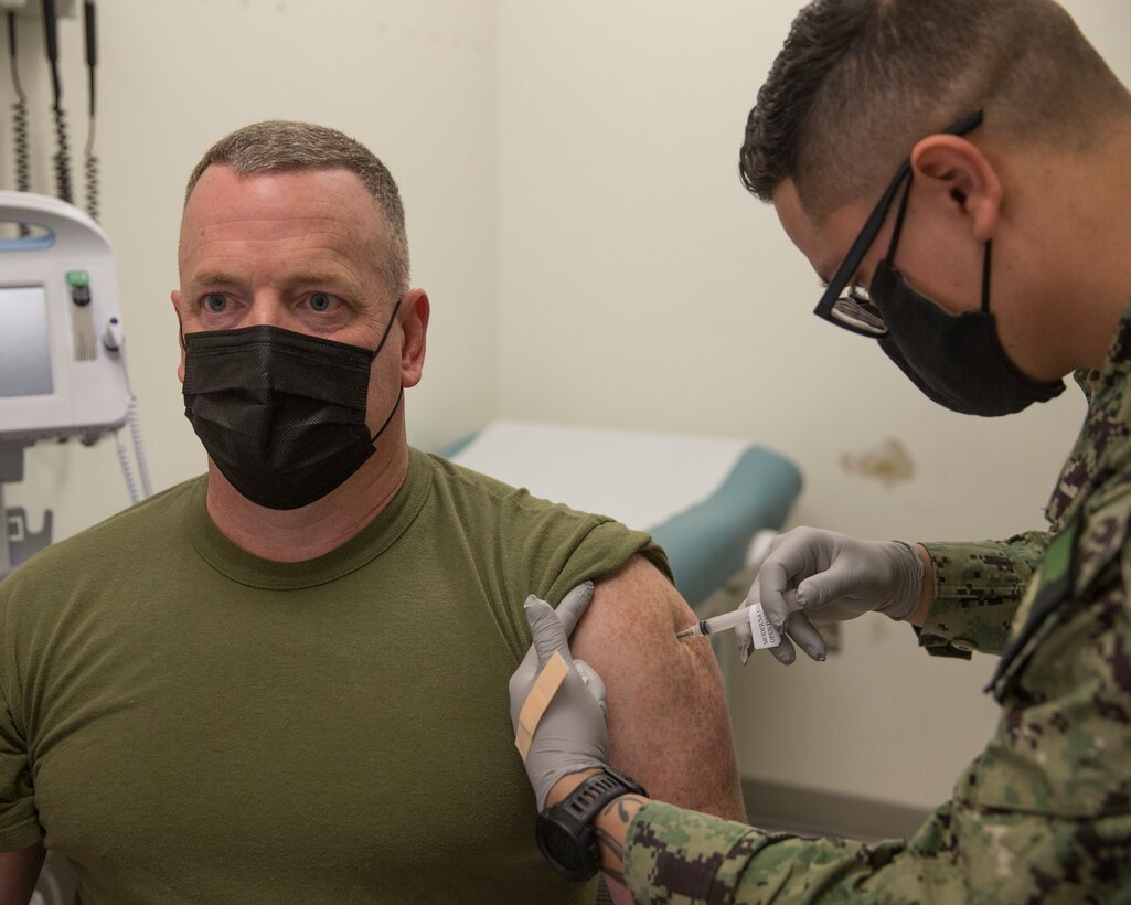U.S. Marine Corps Sgt. Maj. Jason Davey, sergeant major of Marine Corps Air Station (MCAS) Yuma, receives the first dose of the COVID-19 vaccine aboard MCAS Yuma, Ariz., Feb. 5, 2021. Vaccines are being administered in phased approach, prioritizing healthcare workers and first responders, as well as mission critical and deploying personnel. The vaccine is voluntary and Marines are receiving it in order to keep the Corp mission ready. (U.S. Marine Corps photo by Cpl. Jason Monty)