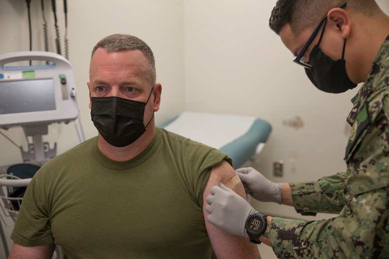 U.S. Marine Corps Sgt. Maj. Jason Davey, sergeant major of Marine Corps Air Station (MCAS) Yuma, receives the first dose of the COVID-19 vaccine aboard MCAS Yuma, Ariz., Feb. 5, 2021. Vaccines are being administered in phased approach, prioritizing healthcare workers and first responders, as well as mission critical and deploying personnel. The vaccine is voluntary and Marines are receiving it in order to keep the Corp mission ready. (U.S. Marine Corps photo by Cpl. Jason Monty)