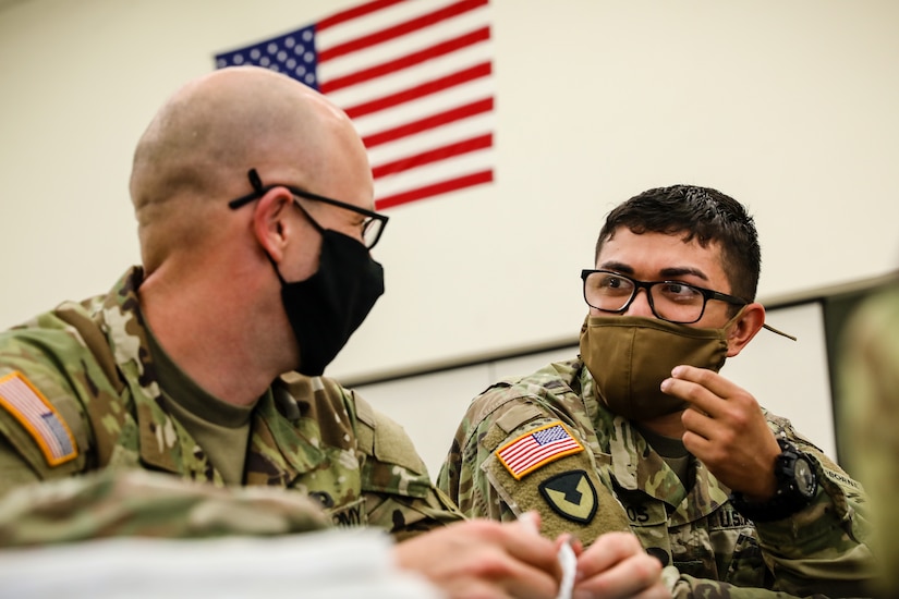 U.S. Army Reserve Spc. Daniel Bush, left, civil affairs specialist with the 353rd Civil Affairs Command, and Staff Sgt. Marco Campos, right, a civil affairs specialist with the 410th Civil Affairs Battalion, greet each other during the inprocessing portion of the 2021 U.S. Army Civil Affairs and Psychological Operations Command (Airborne) Best Warrior Competition at Fort Jackson, S.C. on April 6. Soldiers from across the nation traveled to compete in the 2021 U.S. Army Civil Affairs and Psychological Operations Command (Airborne) Best Warrior Competition, hosted from April 5-10, at Fort Jackson, S.C. The USACAPOC(A) BWC is an annual competition that brings in the best Soldiers across USACAPOC(A) to earn the title of “Best Warrior” among their peers after being evaluated on their individual ability to adapt and overcome challenging scenarios and battle-focused events, testing their technical and tactical abilities under stress and extreme fatigue.