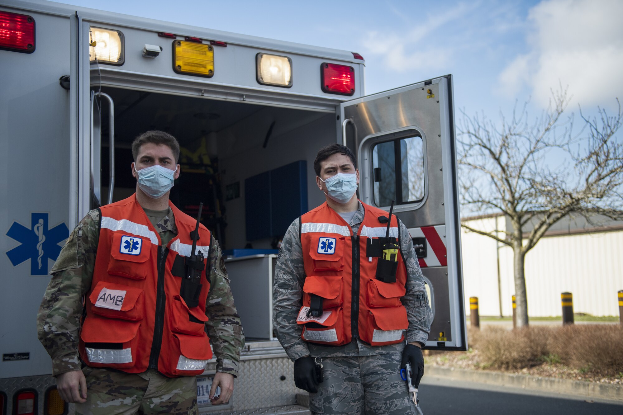 Two U.S. Air Force 52nd Medical Group ambulatory services Airmen pose for a photo near an ambulance at Spangdahlem Air Base, Germany, March 26, 2021. During exercise Ready EAGLE, ambulatory services dispatched to the scene of a simulated disaster at the base theater. (U.S. Air Force photo by Senior Airman Ali Stewart)