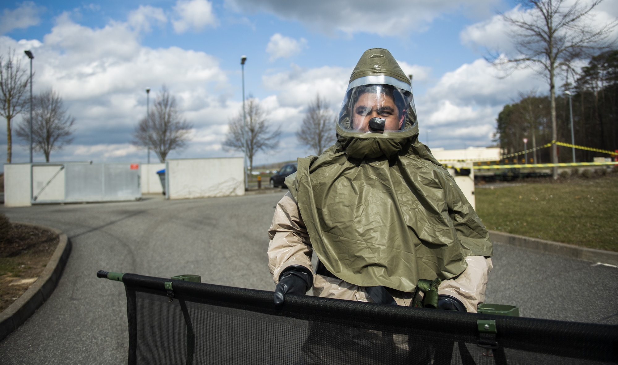 A U.S. Air Force Airman from the 52nd Medical Group carries a gurney to a pop-up decontamination site behind the 52nd MDG at Spangdahlem Air Base, Germany, March 26, 2021. During this portion of the exercise, Airmen subdued and comforted patients in a state of panic from the simulated disaster at the base theater. (U.S. Air Force photo by Senior Airman Ali Stewart)