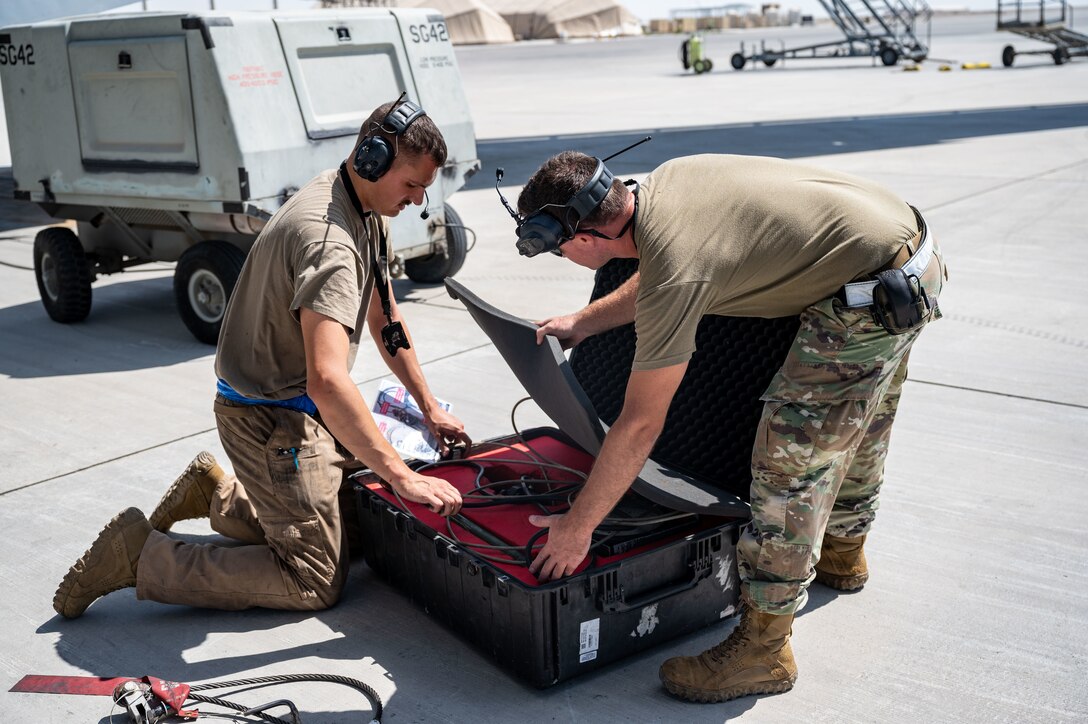 Airman 1st Class Brandon Weber and Staff Sgt. Daniel Destefano pack up equipment.