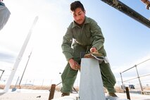 Tech. Sgt. Louis Toth, 373rd Training Squadron Det. 22 electromechanical team instructor, looks on as maintainers conduct training March 19, 2021, at a launch facility near Malmstrom Air Force Base, Mont.