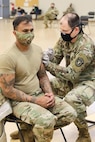 U.S. Army Capt. Jerome C. Ferrin, an Army nurse and recruiter assigned to the U.S. Army Medical Recruiter Center – New York City, administers a COVID-19 vaccine dose to Sgt. 1stClass Chris Mahabir at the Fort Hamilton Armed Forces Reserve Center. U.S. Army Garrison Fort Hamilton and Keller Army Community Hospital coordinated efforts to deliver COVID-19 vaccines to the area community. U.S. Army Courtesy Photo