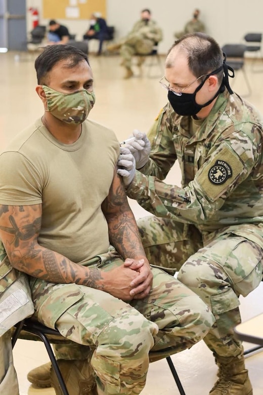 U.S. Army Capt. Jerome C. Ferrin, an Army nurse and recruiter assigned to the U.S. Army Medical Recruiter Center – New York City, administers a COVID-19 vaccine dose to Sgt. 1stClass Chris Mahabir at the Fort Hamilton Armed Forces Reserve Center. U.S. Army Garrison Fort Hamilton and Keller Army Community Hospital coordinated efforts to deliver COVID-19 vaccines to the area community. U.S. Army Courtesy Photo