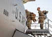 Airmen loading into airplane