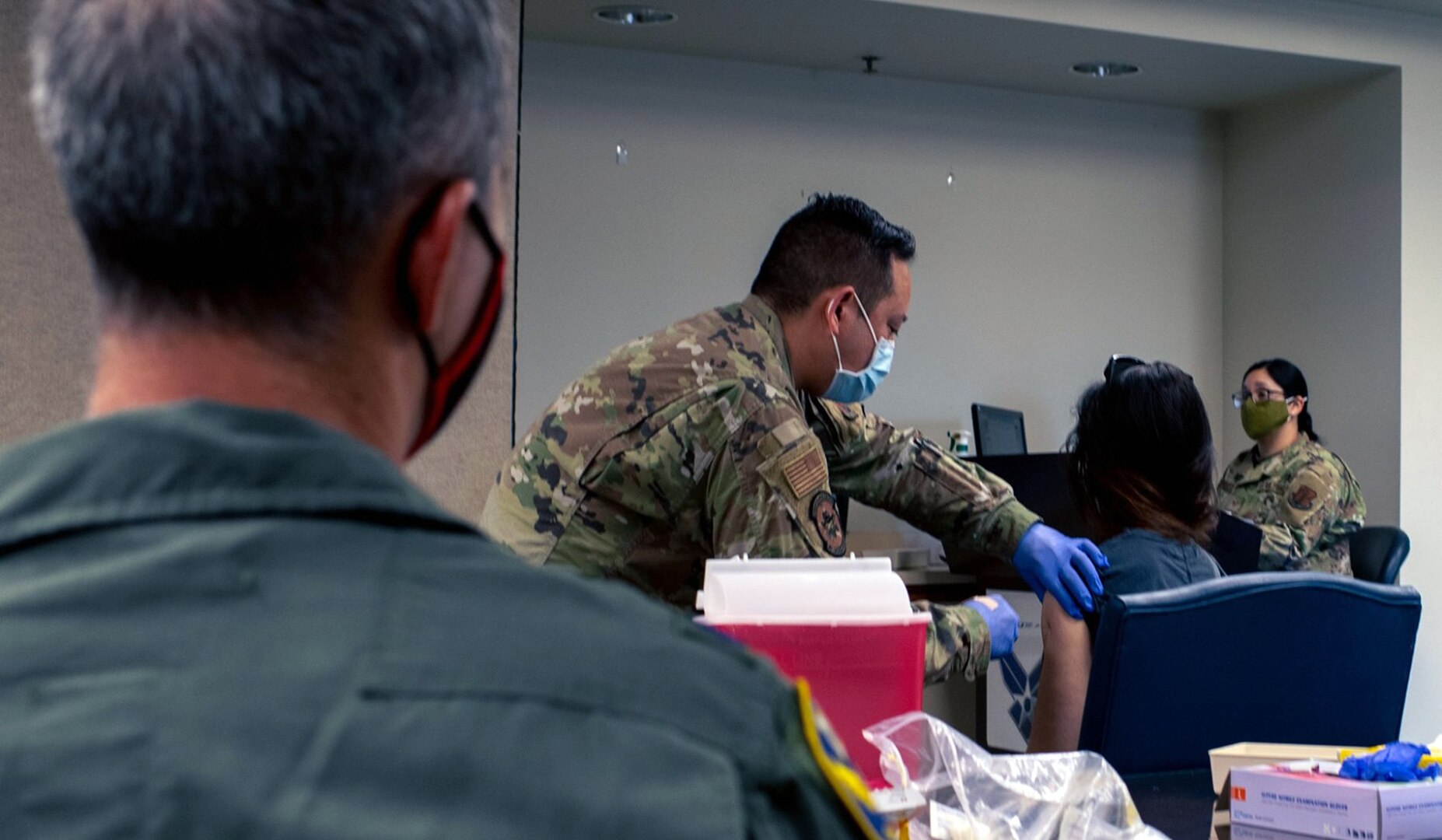 Tech. Sgt. Anthony Montejo, 149th Medical Group readiness noncommissioned officer, gives a COVID-19 vaccination to an active duty member’s spouse during a vaccine clinic on Joint Base San Antonio-Lackland April 1. The 149th MDG is holding weekly COVID-19 vaccination clinics for all eligible beneficiaries.