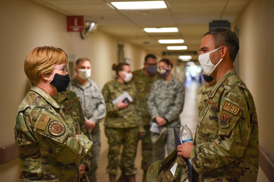 A man and woman talking in a hallway