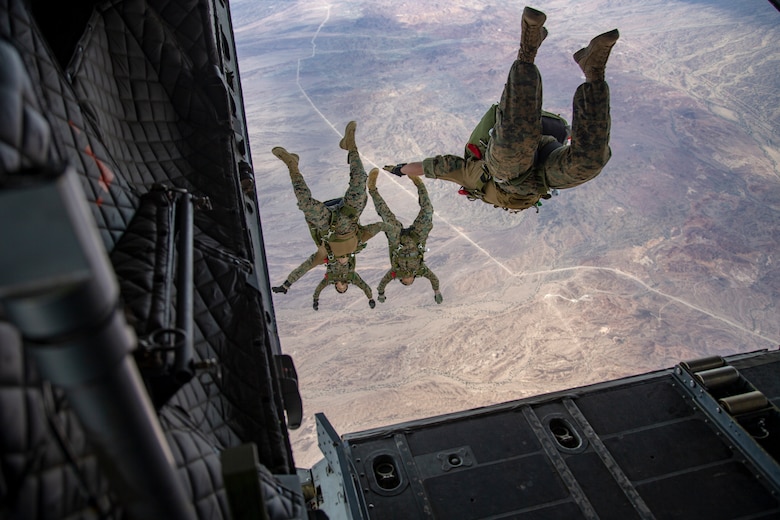 U.S. Marines and Army SOF conduct barrel drops and tandem jumps out of a KC-130J at Yuma Proving Grounds on February 9, 2021. This training teaches them how to jump with personnel or equipment in order to expand their mission capabilities.(U.S. Marine Corps photo by LCpl. Gabrielle Sanders)