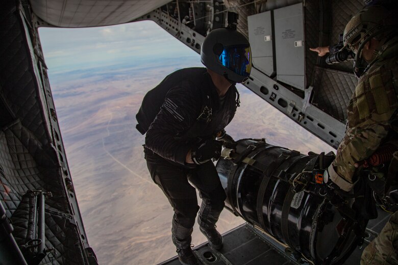 U.S. Marines and Army SOF conduct barrel drops and tandem jumps out of a KC-130J at Yuma Proving Grounds on February 9, 2021. This training teaches them how to jump with personnel or equipment in order to expand their mission capabilities.(U.S. Marine Corps photo by LCpl. Gabrielle Sanders)