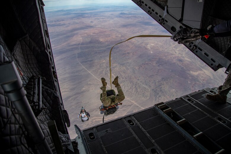 U.S. Marines and Army SOF conduct barrel drops and tandem jumps out of a KC-130J at Yuma Proving Grounds on February 9, 2021. This training teaches them how to jump with personnel or equipment in order to expand their mission capabilities.(U.S. Marine Corps photo by LCpl. Gabrielle Sanders)