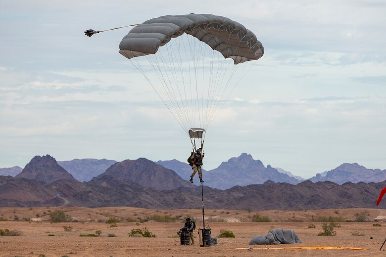 U.S. Marines and Army SOF conduct barrel drops and tandem jumps out of a KC-130J at Yuma Proving Grounds on February 9, 2021. This training teaches them how to jump with personnel or equipment in order to expand their mission capabilities.(U.S. Marine Corps photo by LCpl. Gabrielle Sanders)