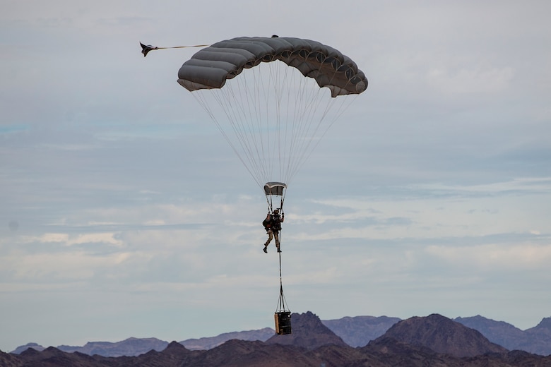 U.S. Marines and Army SOF conduct barrel drops and tandem jumps out of a KC-130J at Yuma Proving Grounds on February 9, 2021. This training teaches them how to jump with personnel or equipment in order to expand their mission capabilities.(U.S. Marine Corps photo by LCpl. Gabrielle Sanders)
