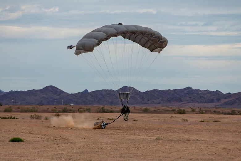 U.S. Marines and Army SOF conduct barrel drops and tandem jumps out of a KC-130J at Yuma Proving Grounds on February 9, 2021. This training teaches them how to jump with personnel or equipment in order to expand their mission capabilities.(U.S. Marine Corps photo by LCpl. Gabrielle Sanders)