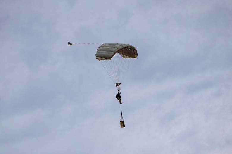 U.S. Marines and Army SOF conduct barrel drops and tandem jumps out of a KC-130J at Yuma Proving Grounds on February 9, 2021. This training teaches them how to jump with personnel or equipment in order to expand their mission capabilities.(U.S. Marine Corps photo by LCpl. Gabrielle Sanders)