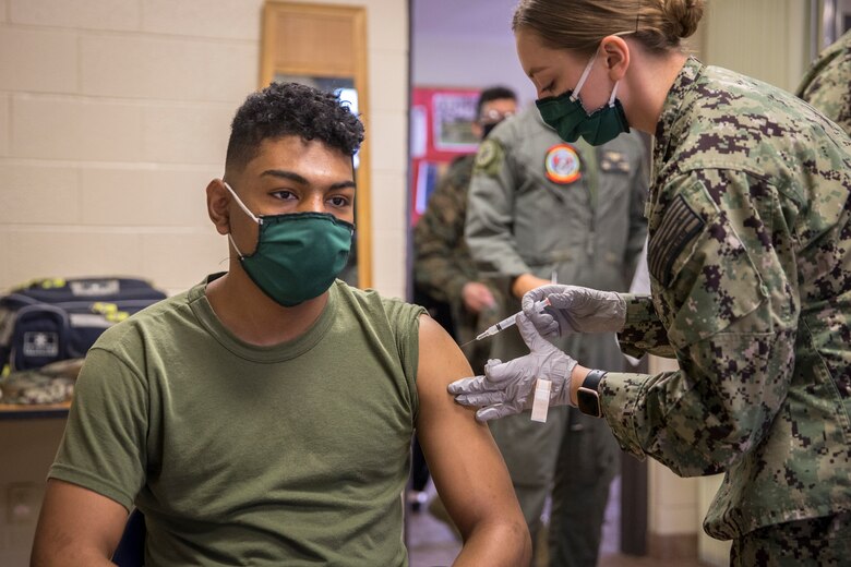U.S. Marines stationed on Marine Corps Air Station (MCAS) Yuma, receive their COVID-19 vaccination on MCAS Yuma, Ariz., Feb. 16, 2021. Vaccines are being administered in phased approach, prioritizing healthcare workers and first responders, as well as mission critical and deploying personnel. The vaccine is voluntary and Marines are receiving it in order to keep the Corps mission ready. (U.S. Marine Corps photo by Lance Cpl John Hall)
