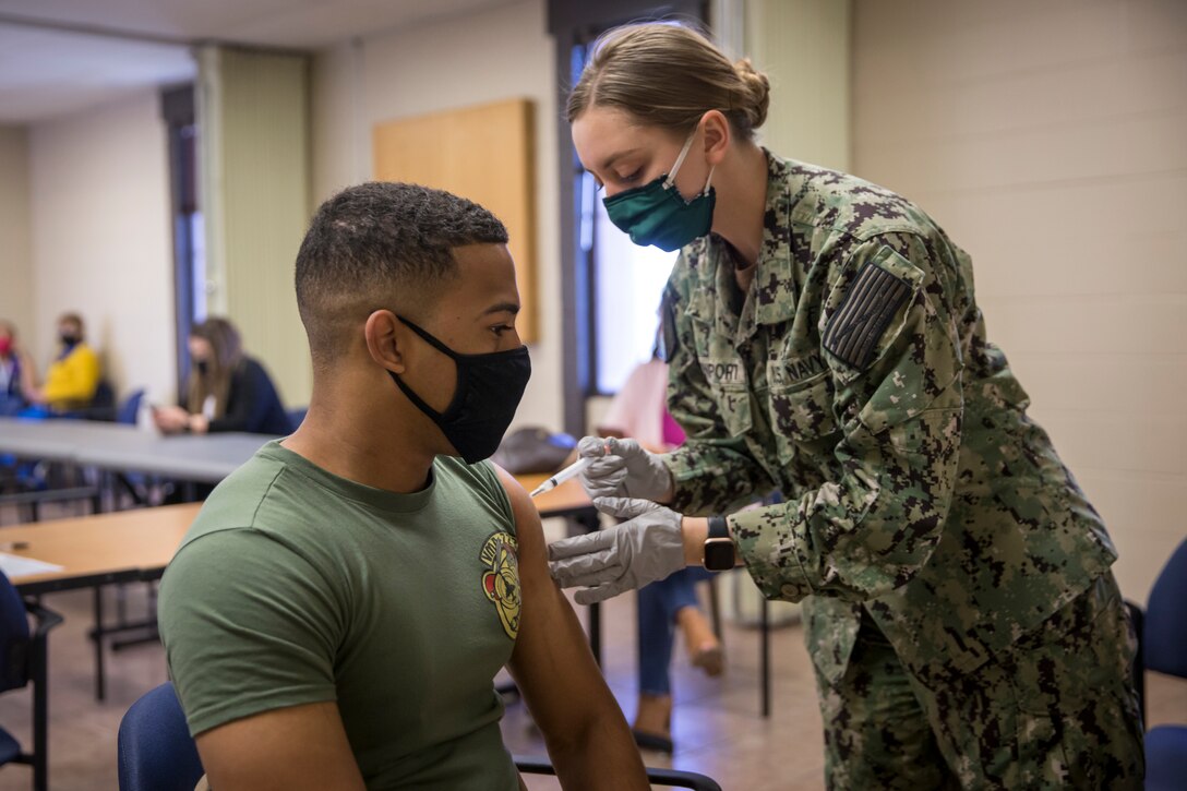 U.S. Marines stationed on Marine Corps Air Station (MCAS) Yuma, receive their COVID-19 vaccination on MCAS Yuma, Ariz., Feb. 16, 2021. Vaccines are being administered in phased approach, prioritizing healthcare workers and first responders, as well as mission critical and deploying personnel. The vaccine is voluntary and Marines are receiving it in order to keep the Corps mission ready. (U.S. Marine Corps photo by Lance Cpl John Hall)